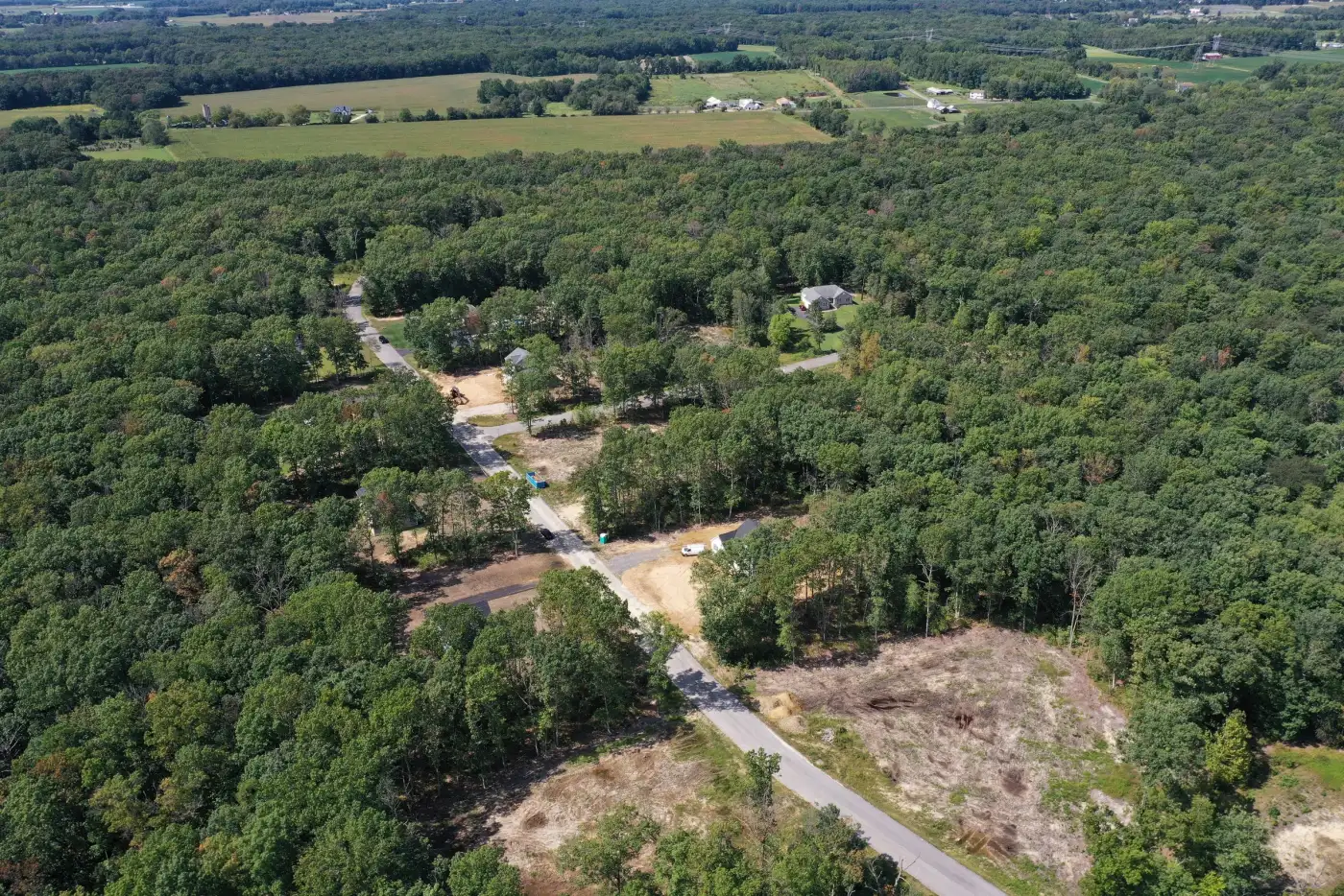 Aerial view of cleared building lots along a new road in a wooded South Jersey subdivision